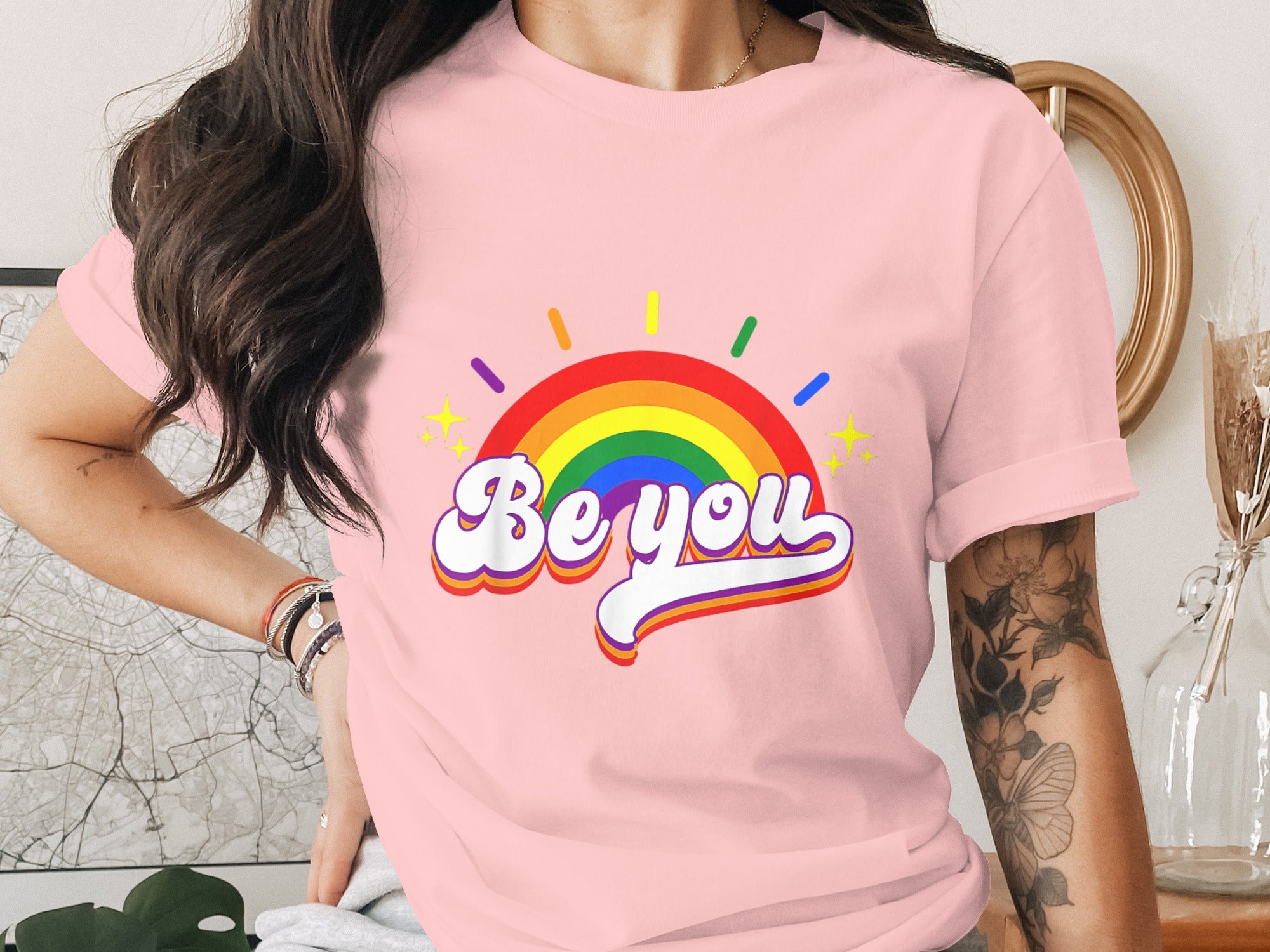 Pink t-shirt with rainbow and "Be you" text, featuring stars.