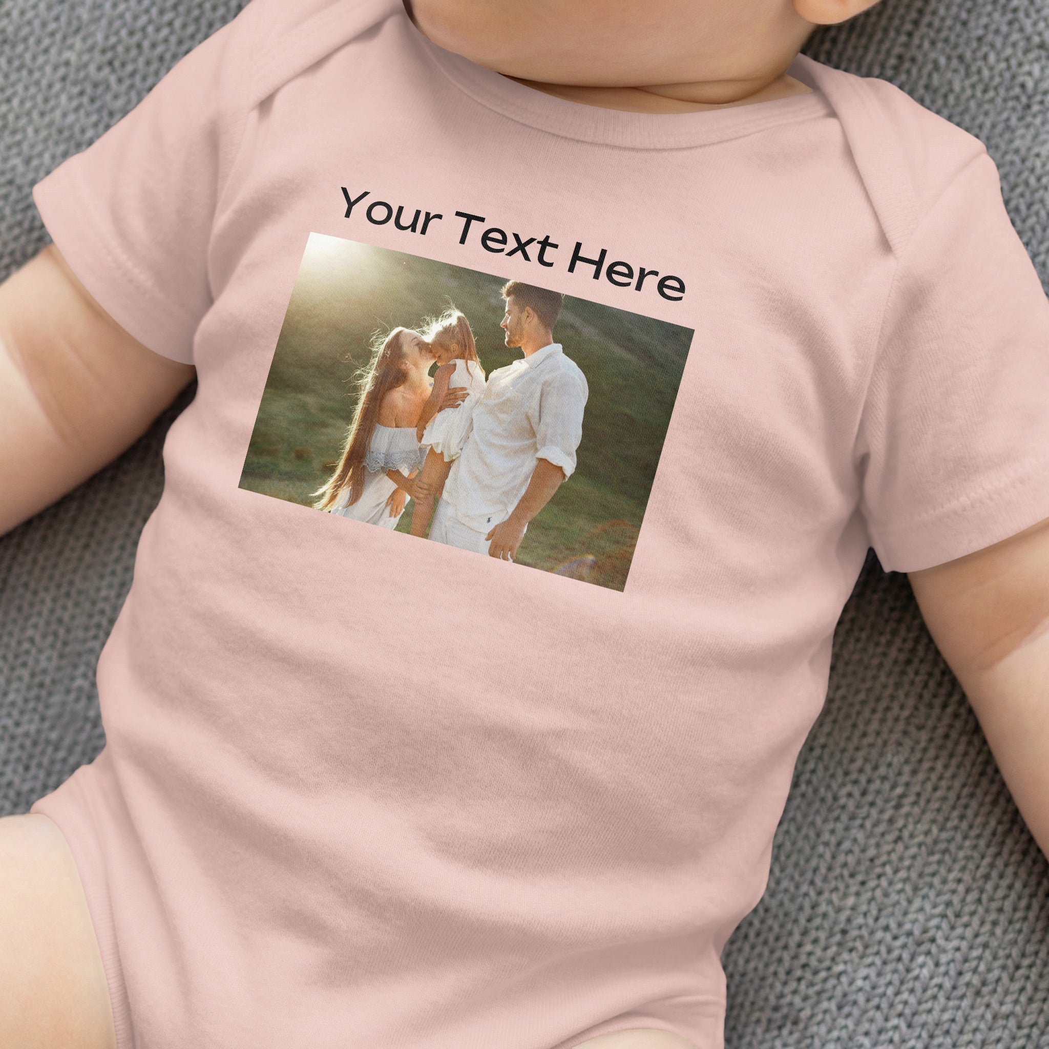 Pink baby onesie with custom text "Your Text Here" and a family photo.