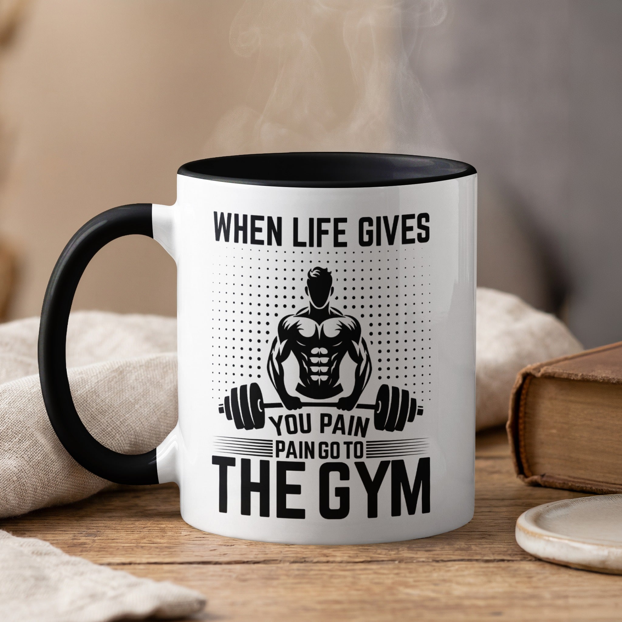 Mug with text "When life gives you pain go to the gym" and muscular man illustration.