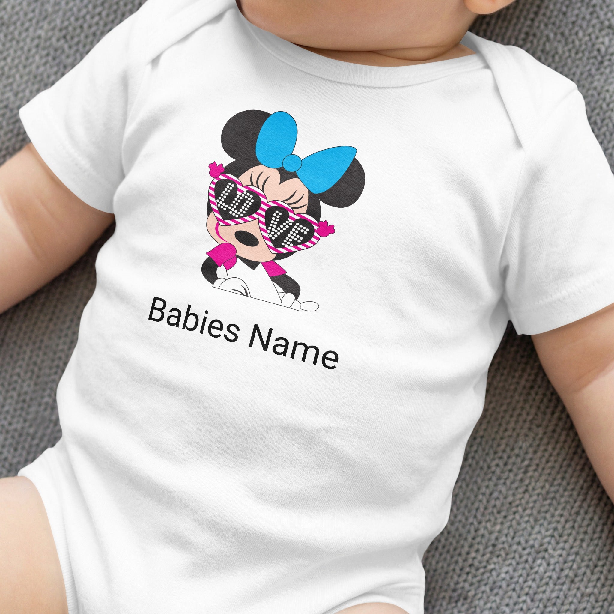White baby onesie with Minnie Mouse graphic wearing sunglasses and "Babies Name" text.
