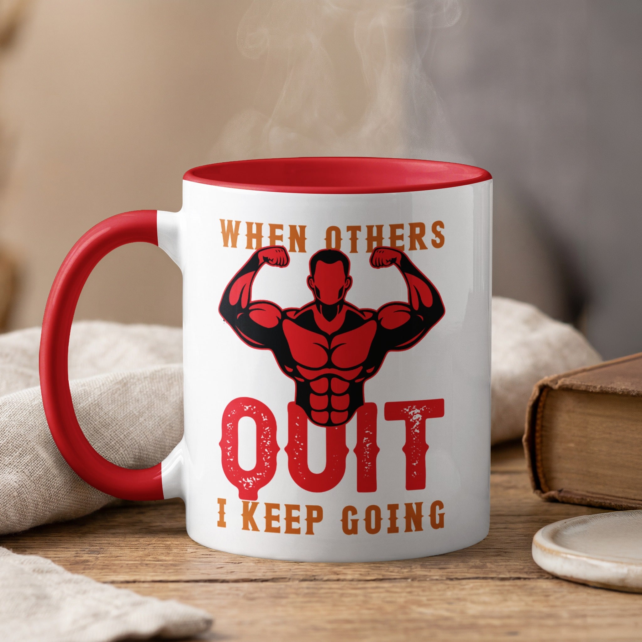 Mug with red rim and handle, featuring silhouette of muscular man and text "When others QUIT I keep going".