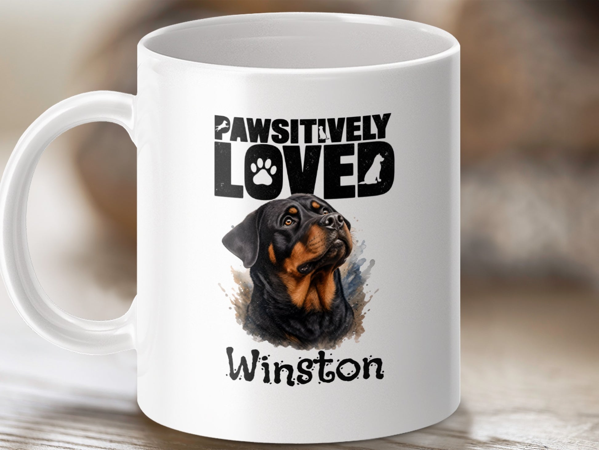White mug with Rottweiler illustration and "Pawsitively" text.