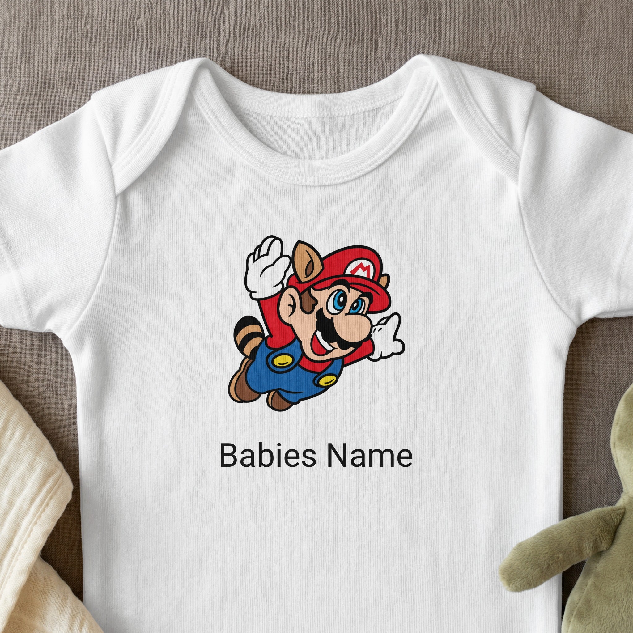 White baby onesie with Mario character and customizable name.