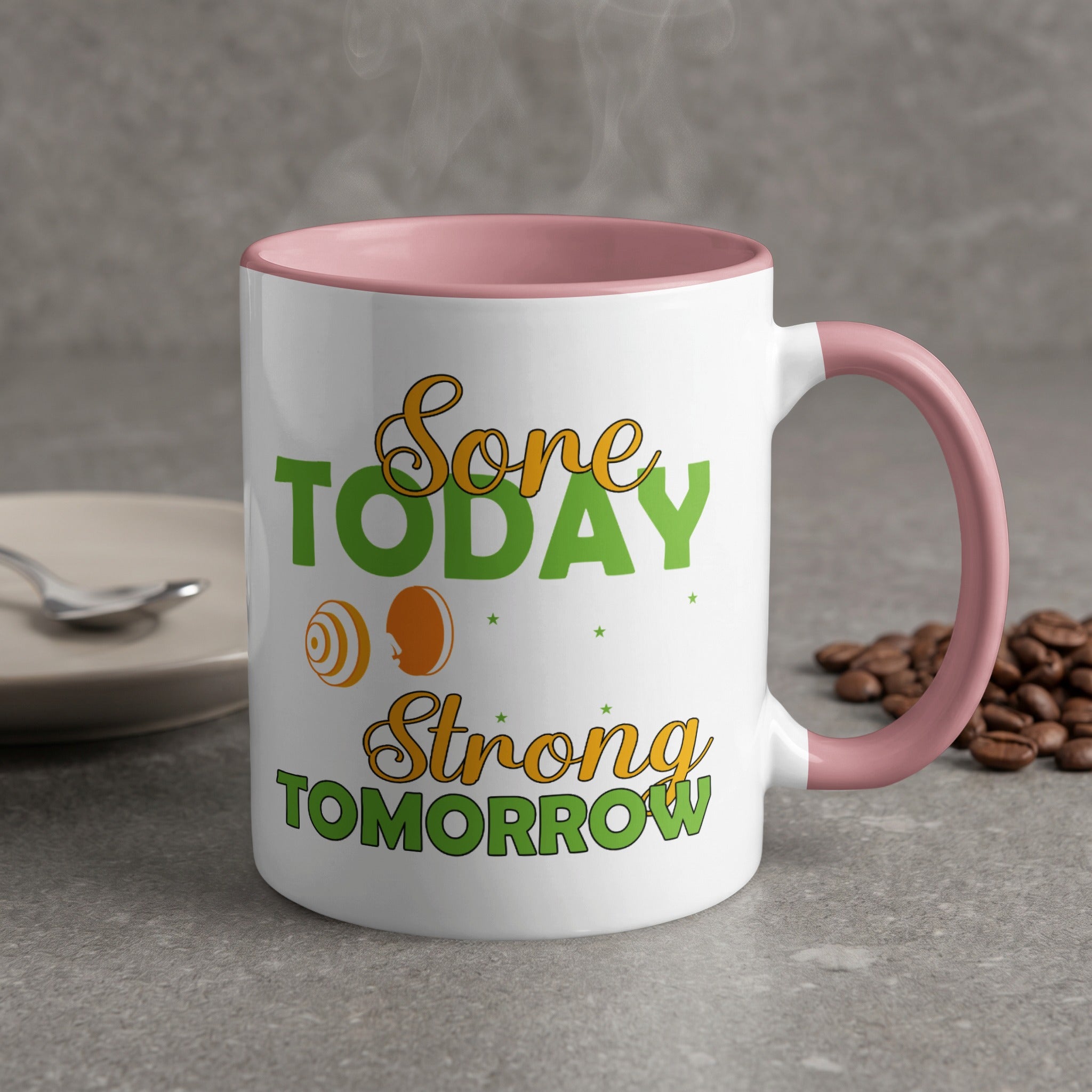 White mug with pink handle, text "Done Today, Strong Tomorrow" and barbell icon.