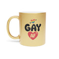 Gold mug with rainbow heart, arrow, and "Gay AF" text.
