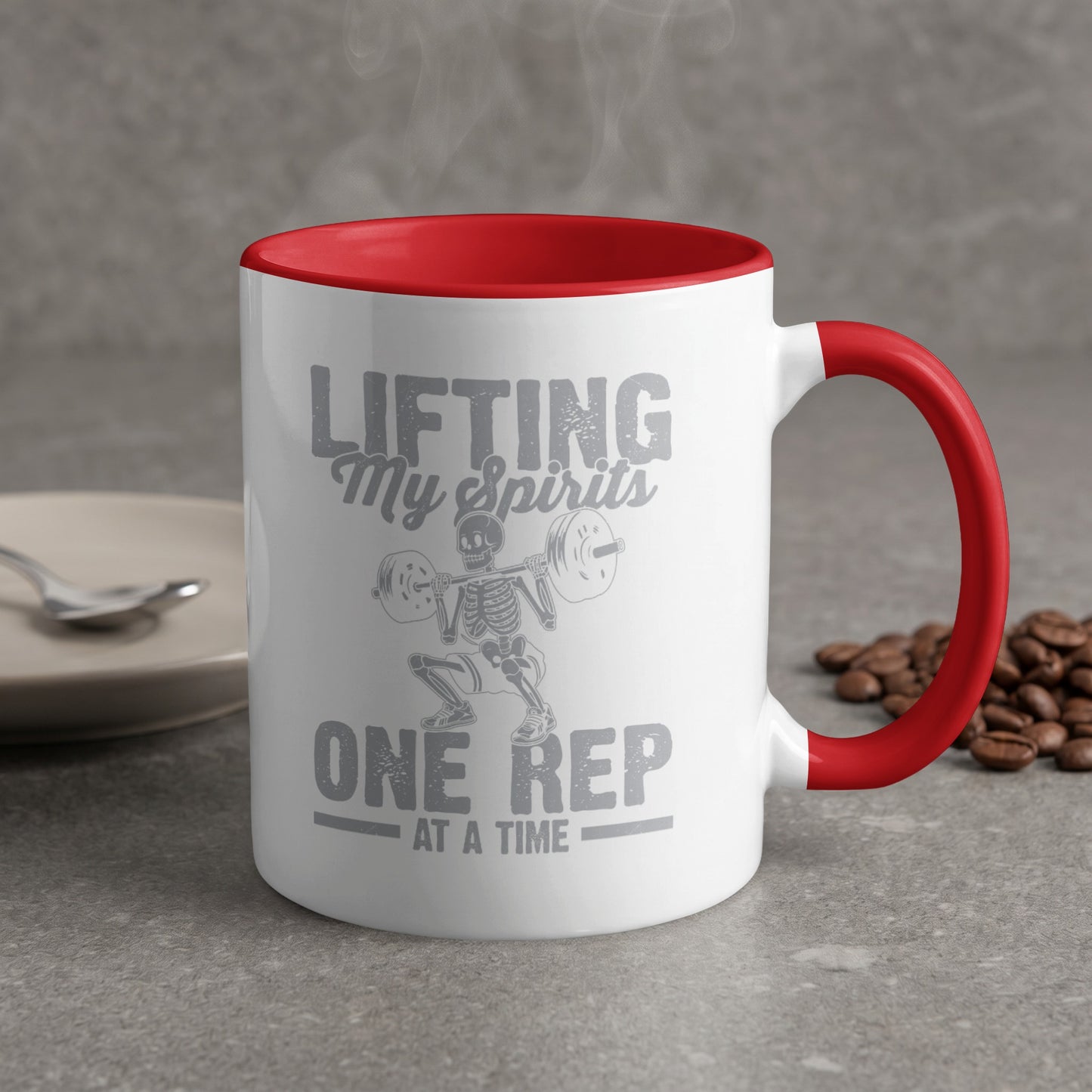 White mug with red handle and "Lifting My Spirits One Rep At A Time" text.