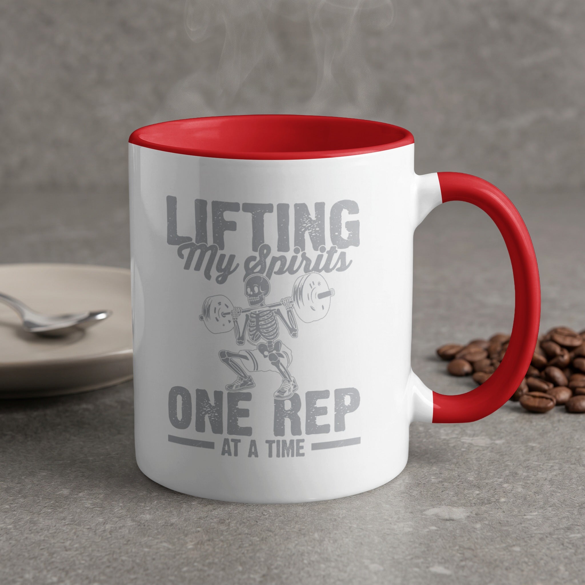 White mug with red handle and "Lifting My Spirits One Rep At A Time" text.