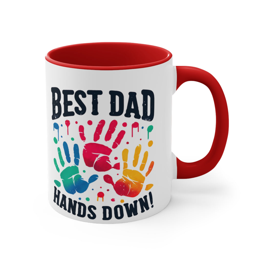 White mug with red handle featuring colorful handprints and text "BEST DAD HANDS DOWN!".