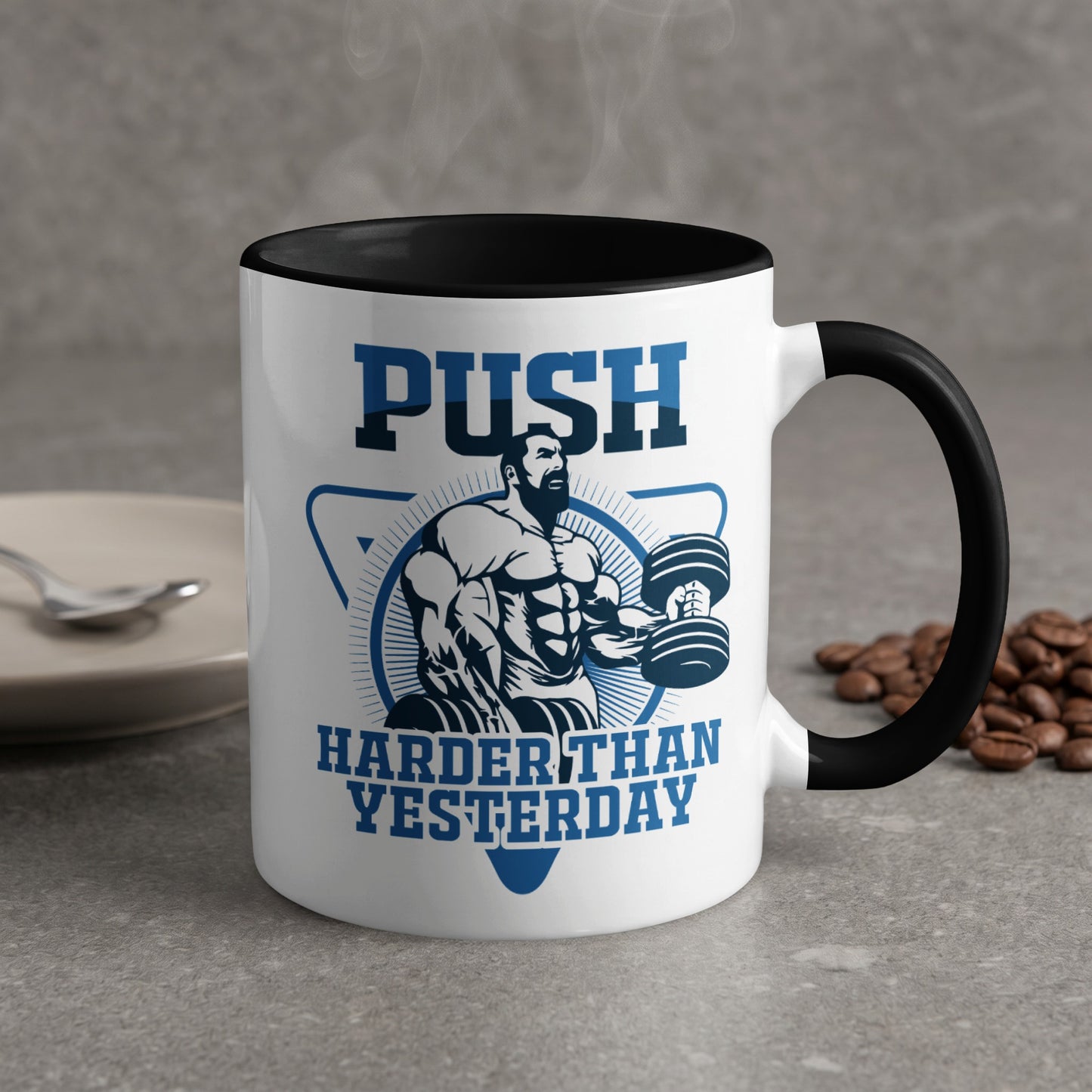 Mug with "PUSH HARDER THAN YESTERDAY" text and muscular man lifting weights.