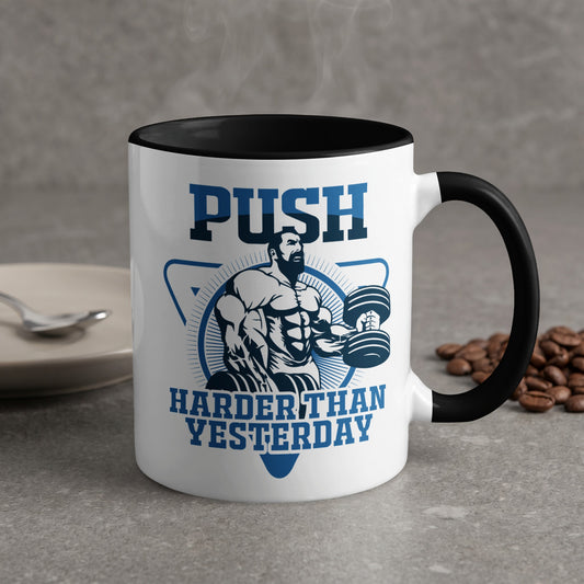 Mug with "PUSH HARDER THAN YESTERDAY" text and muscular man lifting weights.