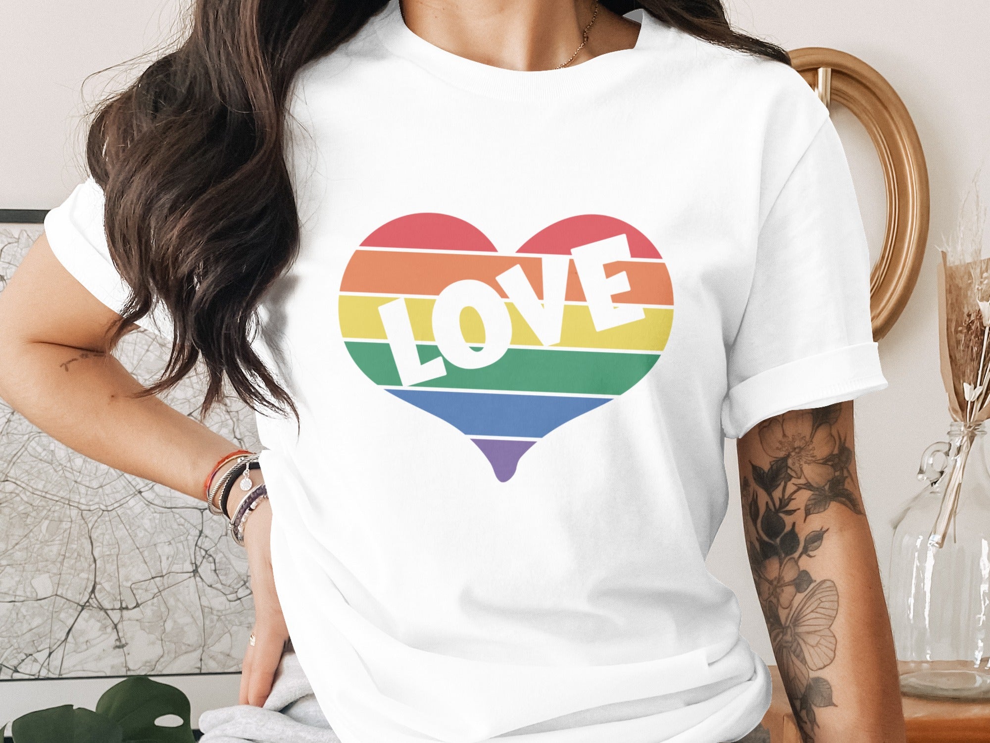 White t-shirt with a rainbow heart graphic that says "LOVE".