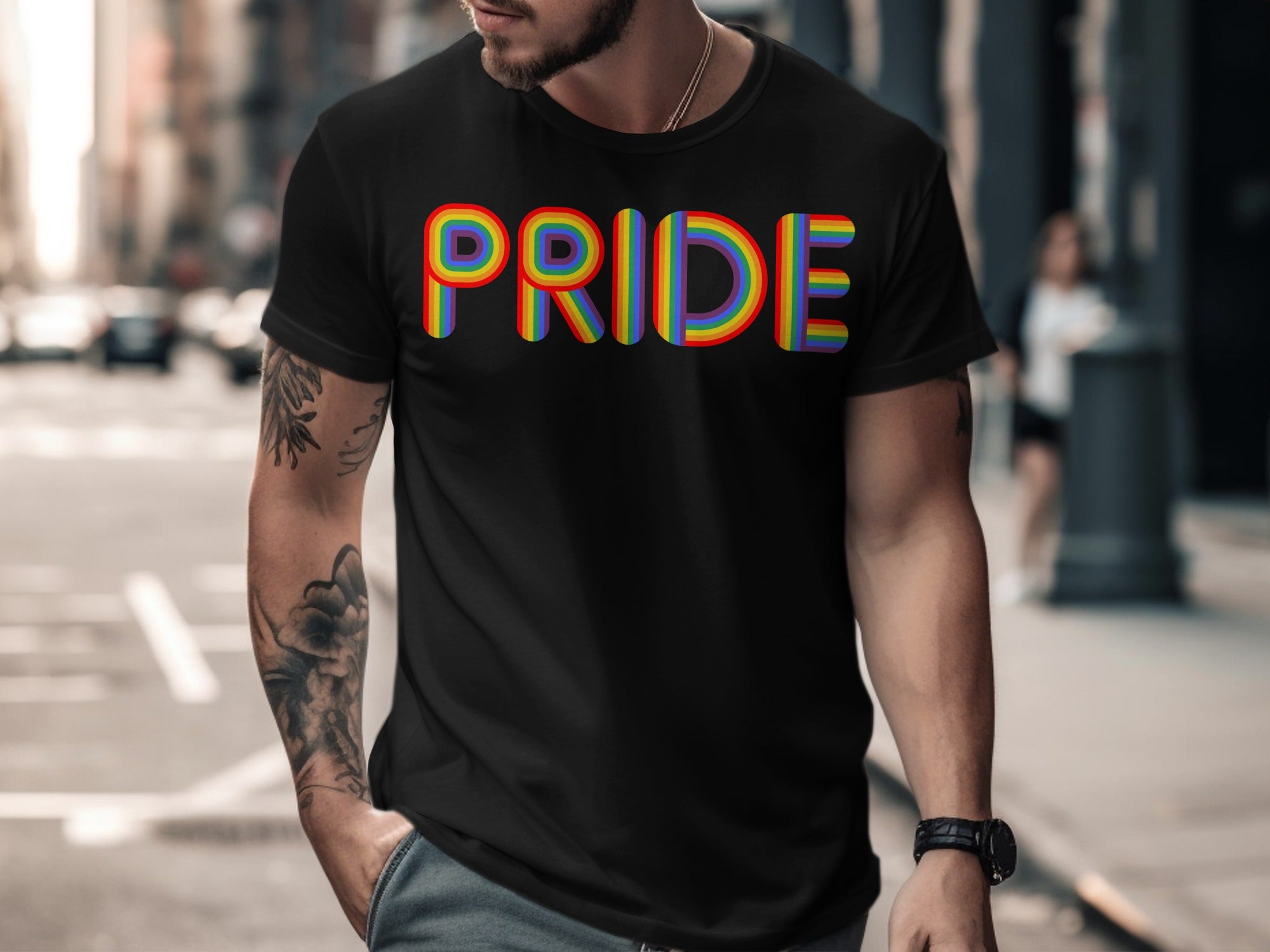 Black t-shirt with rainbow-colored "PRIDE" text and arm tattoo.