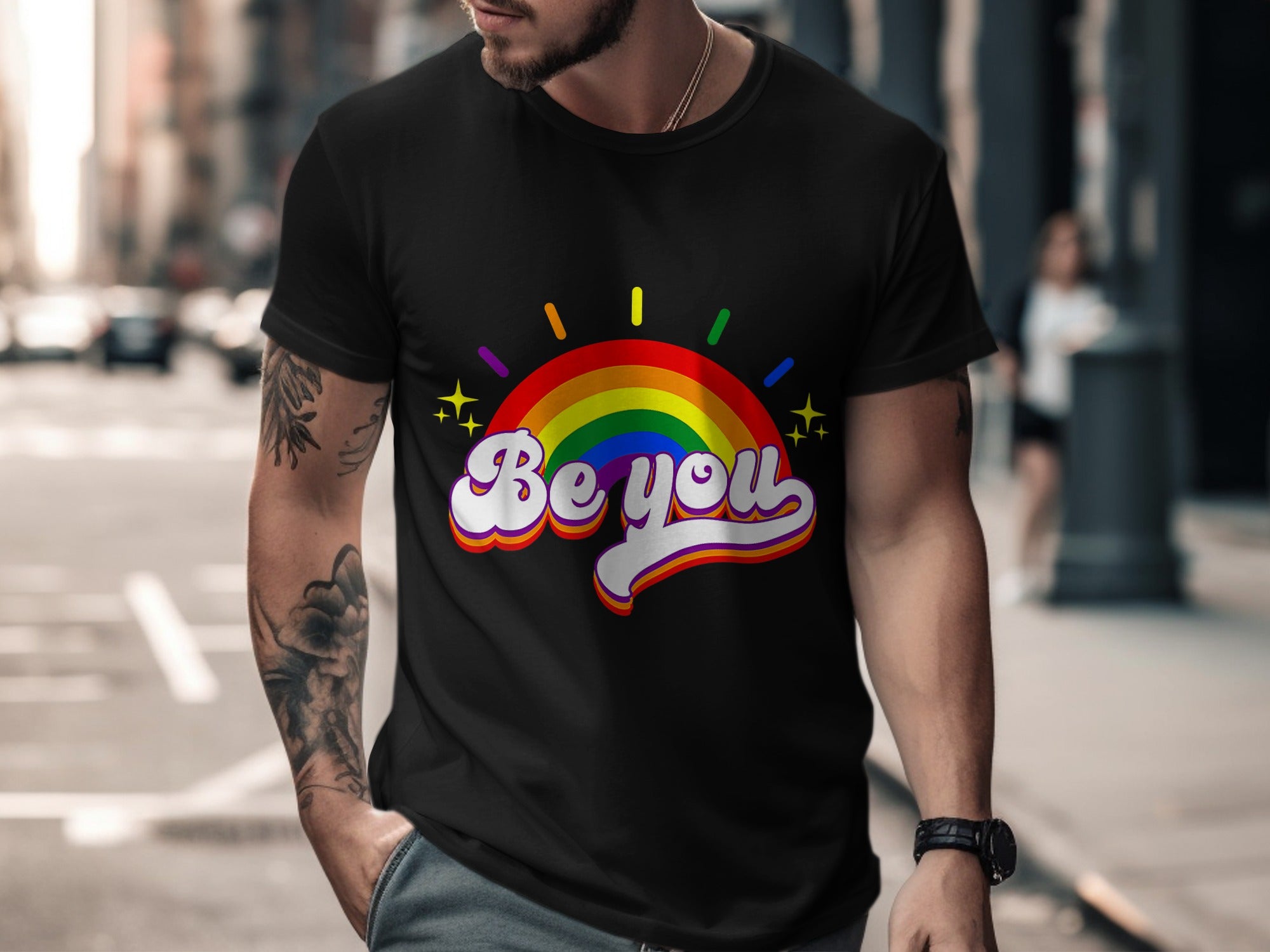 Black t-shirt with rainbow arc graphic and "Be you" text.