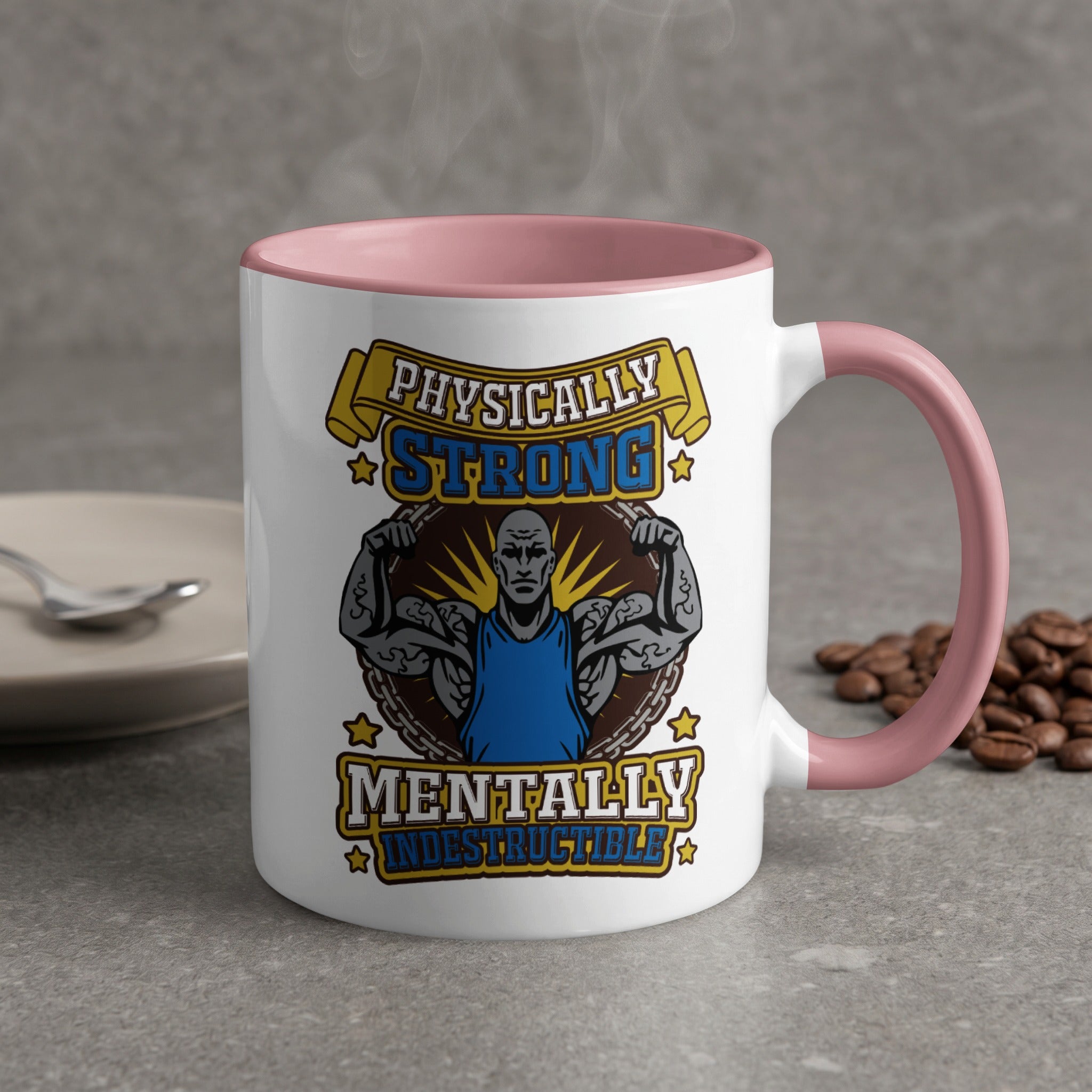 White mug with pink handle, featuring text and graphic for "Physically Strong Mentally Indestructible".