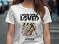 White t-shirt with "PAWSITIVELY LOVED" text and bulldog portrait named Charlie.