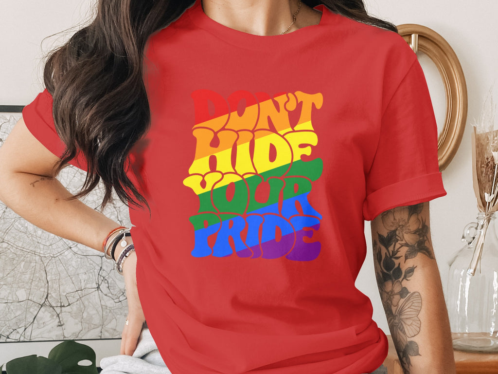 Red t-shirt with rainbow text that says "DON'T HIDE YOUR PRIDE".