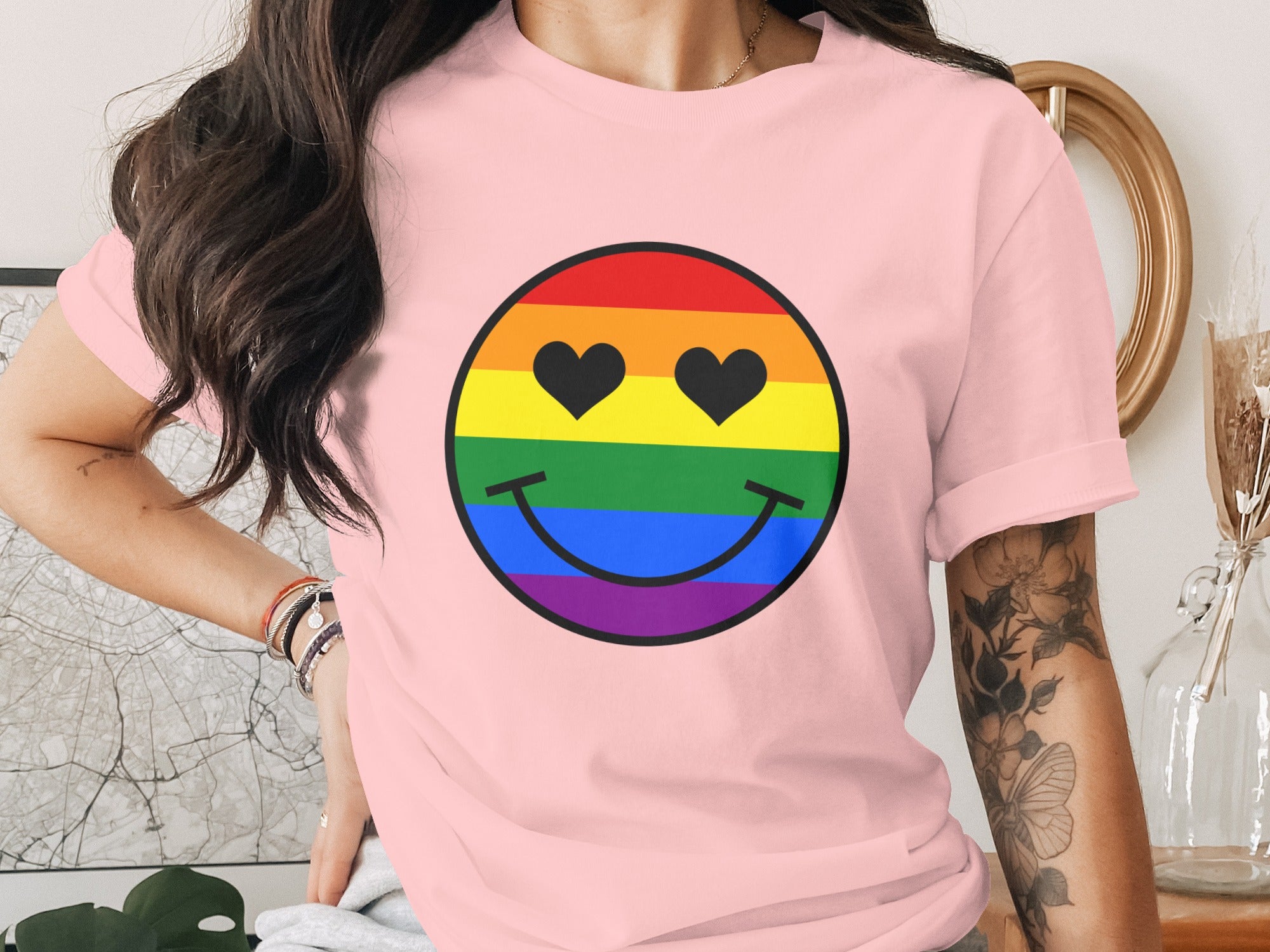 Pink t-shirt featuring a rainbow smiley face with heart-shaped eyes.