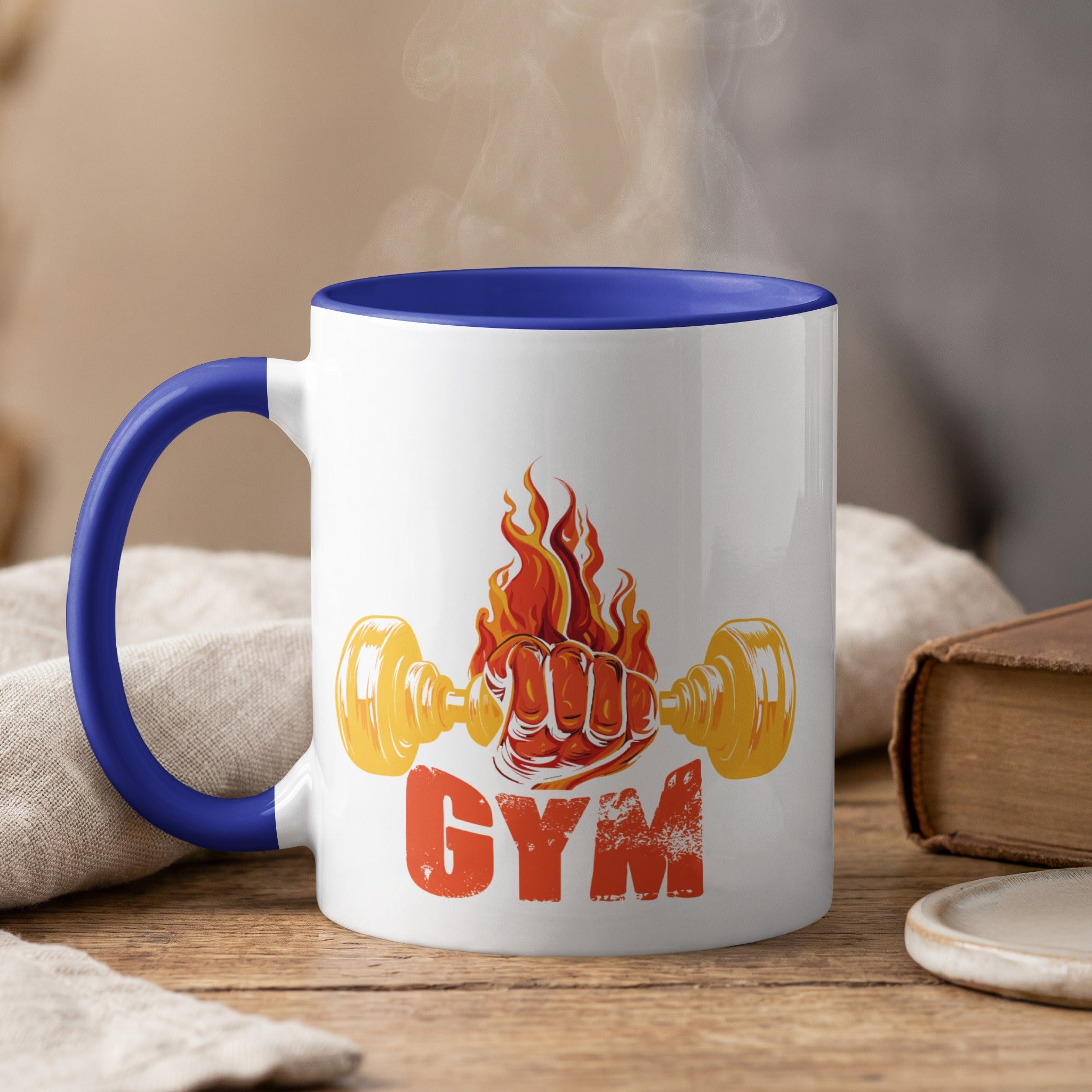 White mug with blue handle, "GYM" text and flaming dumbbell graphic.