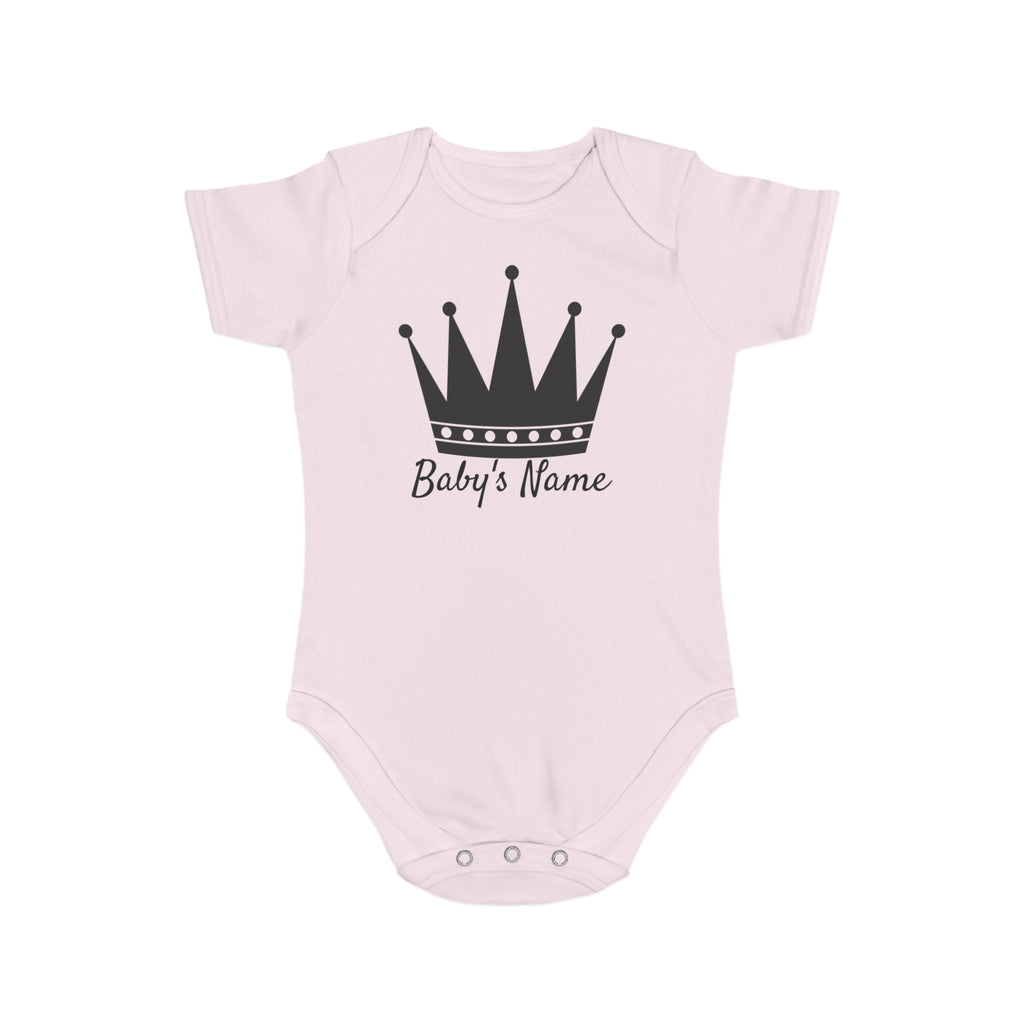 Pink baby onesie with black crown and "Baby's Name" text.