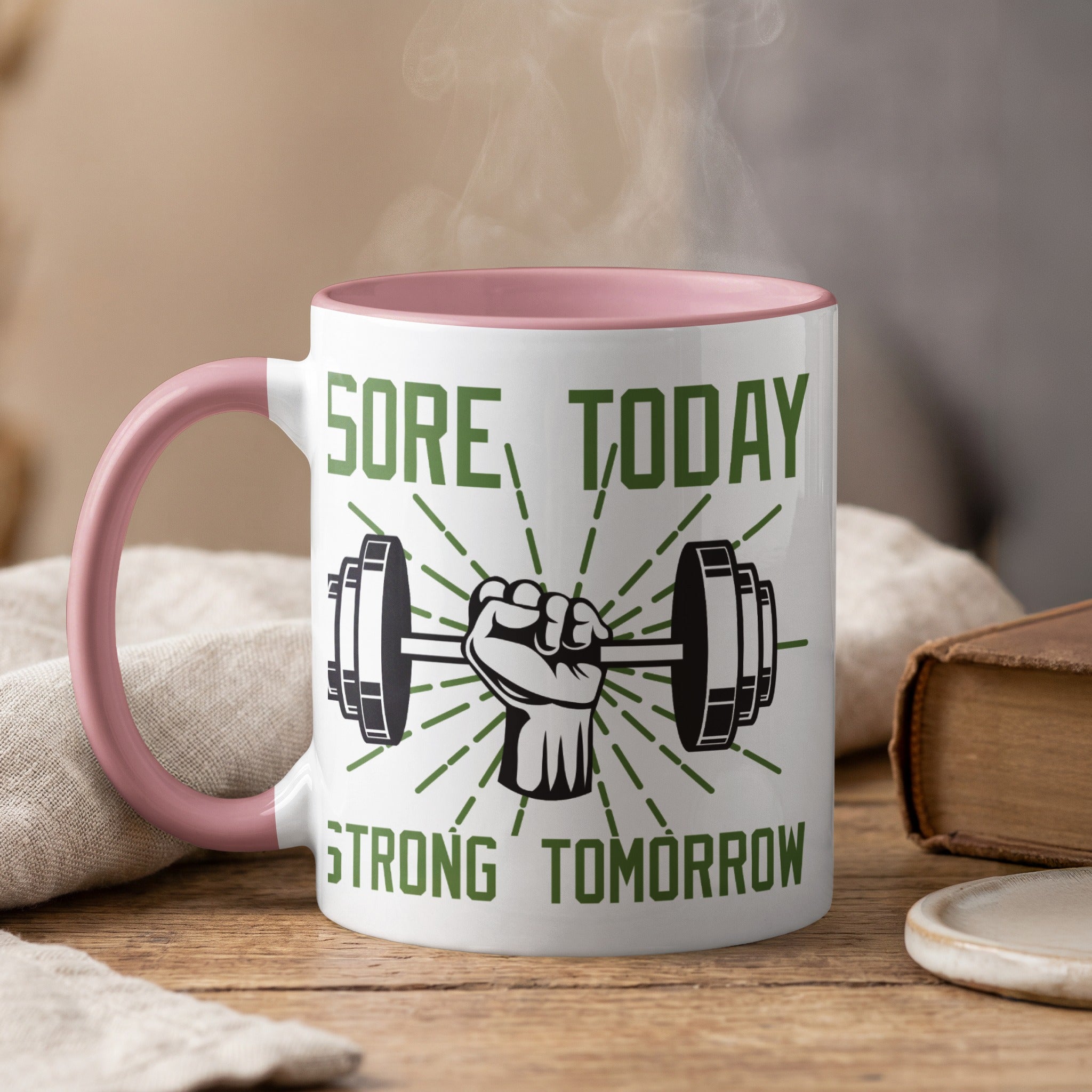White mug with pink handle, "Sore Today Strong Tomorrow" text and a weightlifting graphic.