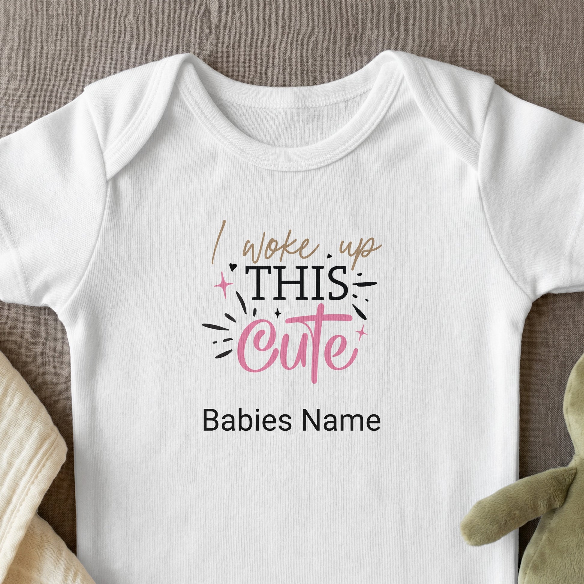 White baby onesie with "I woke up THIS cute" text and a space for a baby's name.