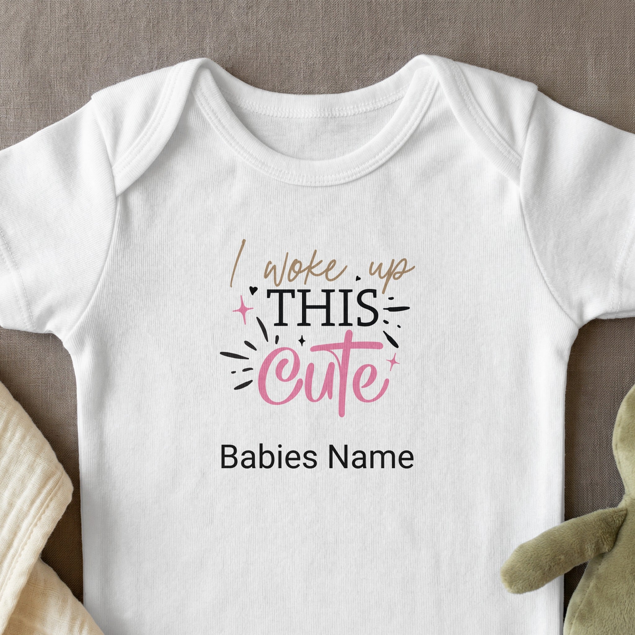 White baby onesie with "I woke up THIS cute" text and a space for a baby's name.