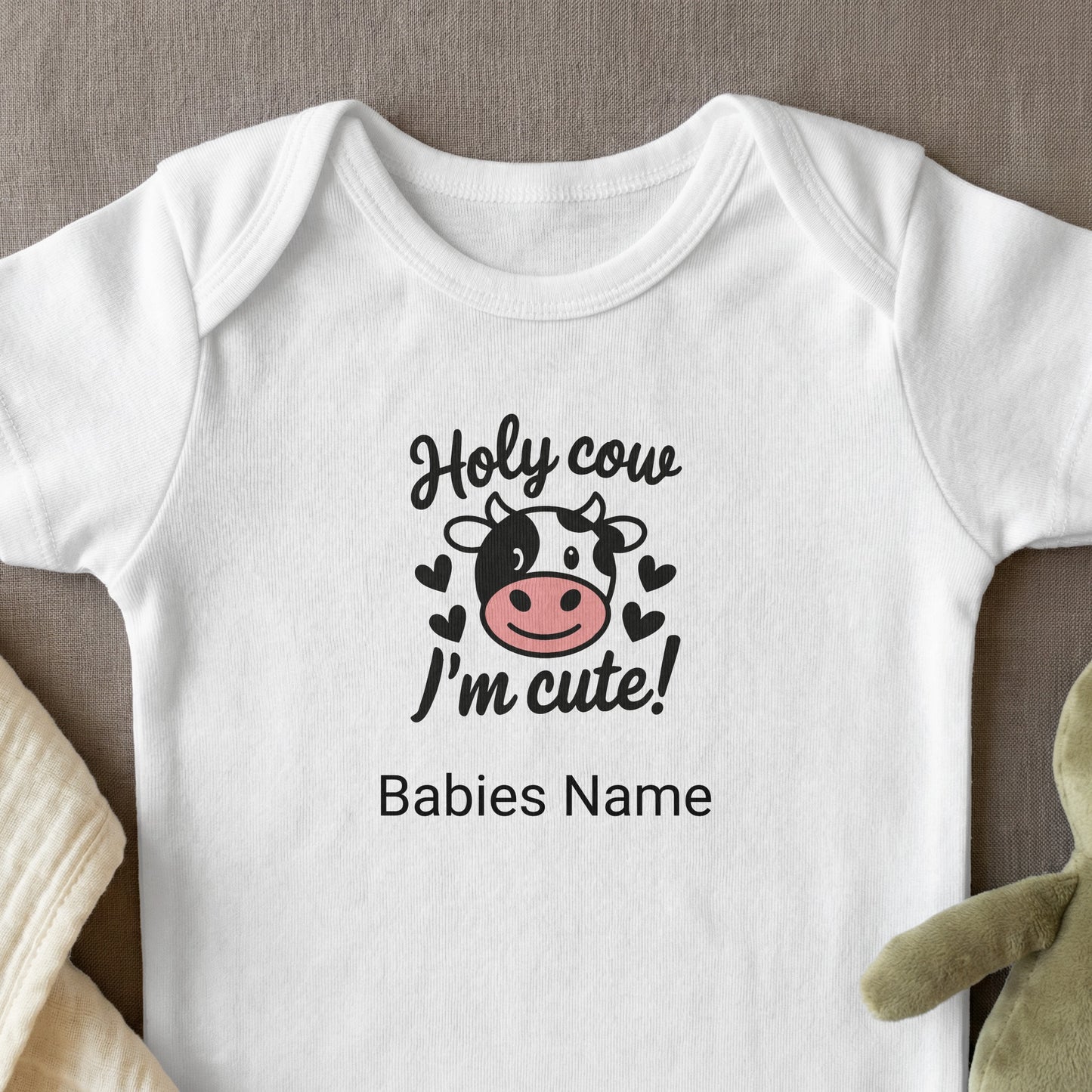 Baby onesie with "Holy cow I'm cute!" and cow graphic.