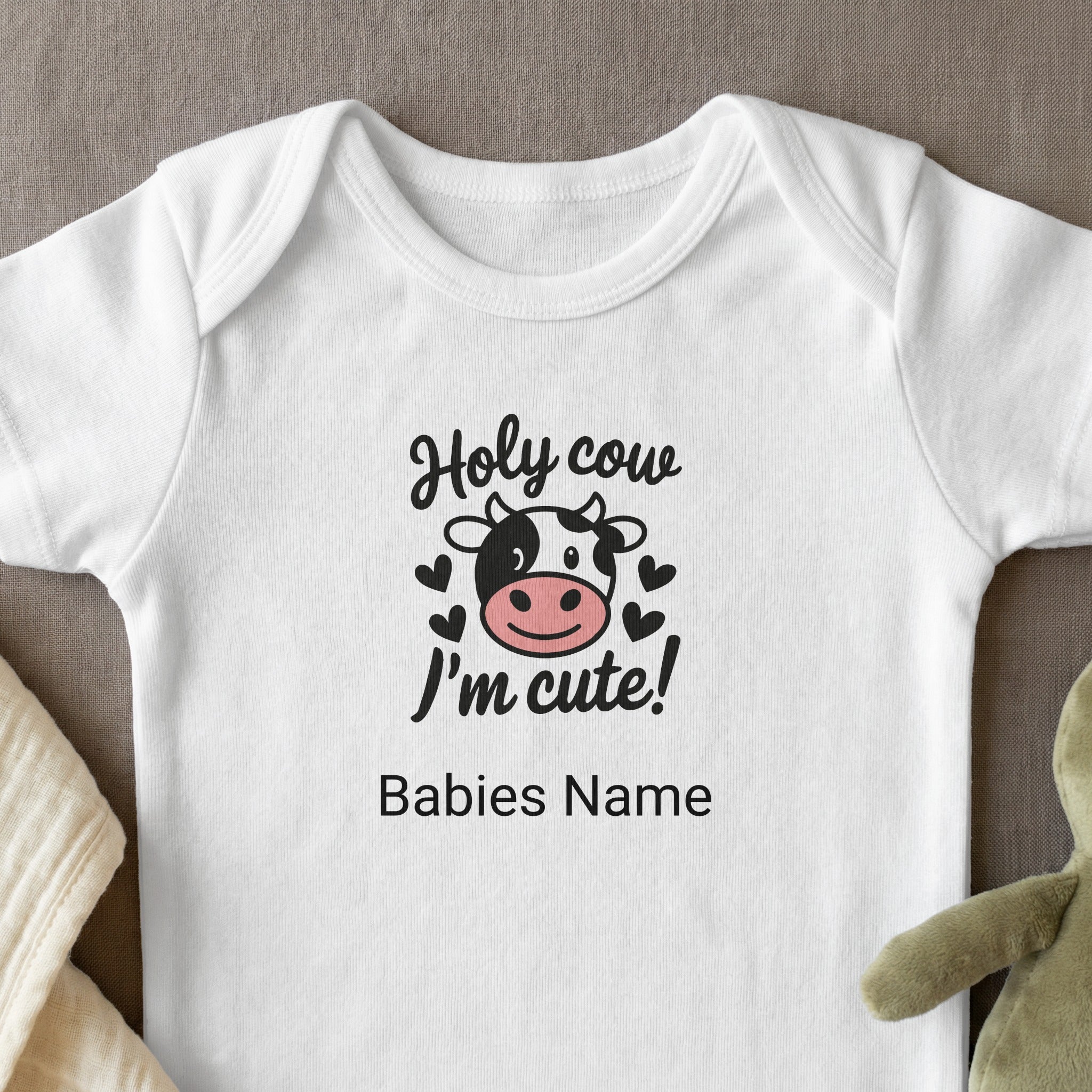 Baby onesie with "Holy cow I'm cute!" and cow graphic.