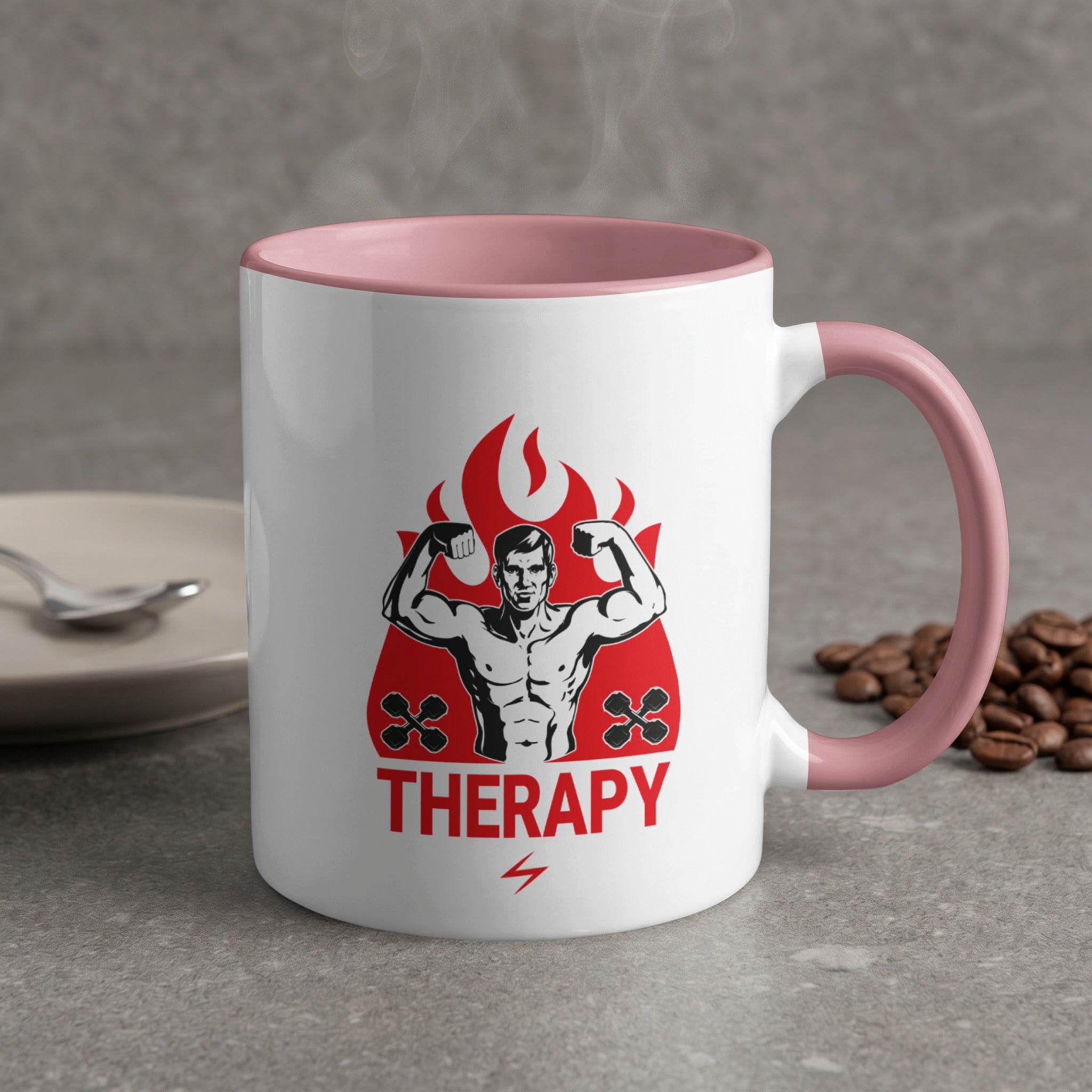 White mug with pink rim featuring muscular man flexing, fire, and the word THERAPY.