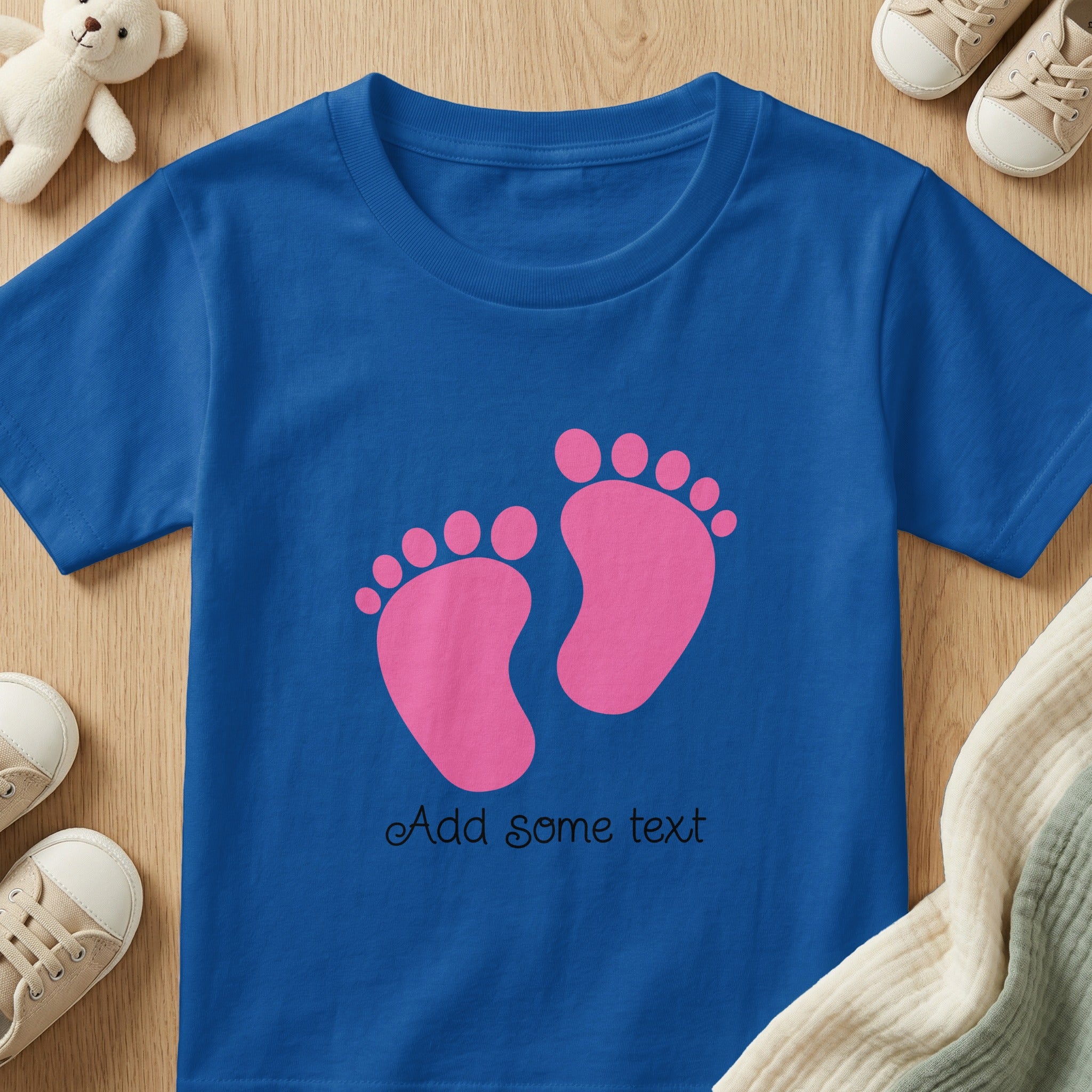 Royal blue t-shirt with pink footprints and "Add some text".