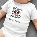 White baby onesie with "Holy cow I'm cute!" and cow design.
