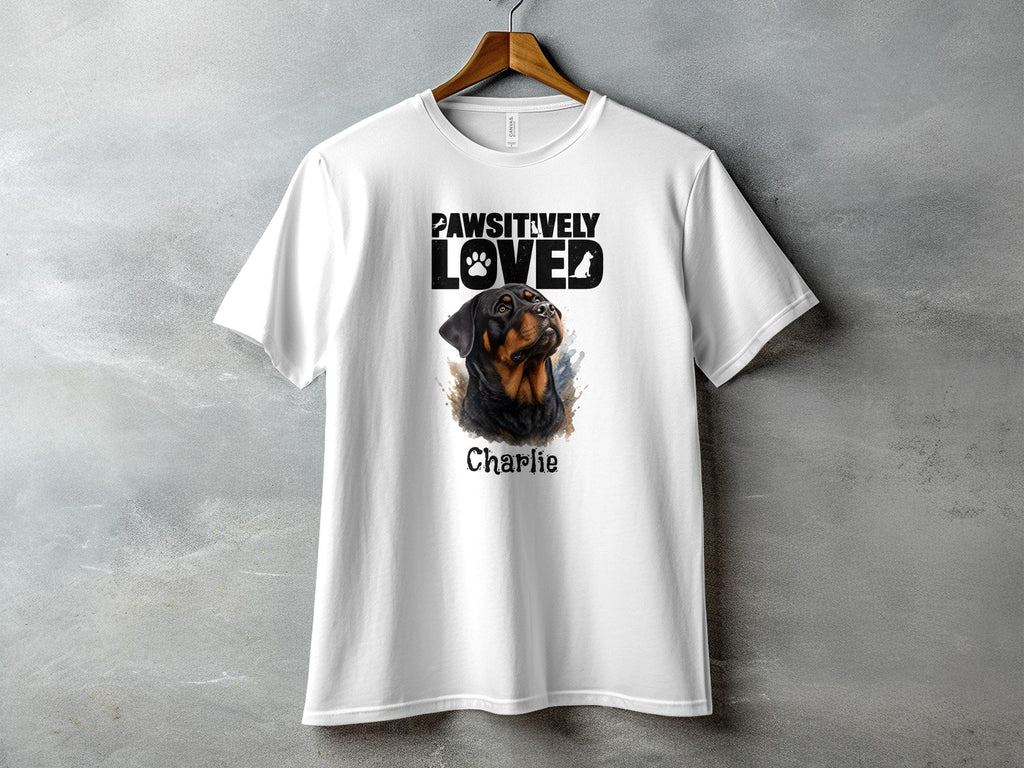 White t-shirt with "PAWSITIVELY LOVED" text and Rottweiler portrait named Charlie.