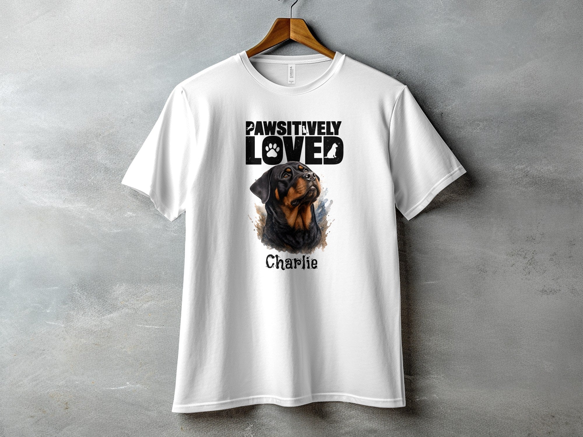 White t-shirt with "PAWSITIVELY LOVED" text and Rottweiler portrait named Charlie.