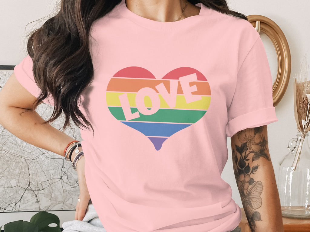 Pink t-shirt with a rainbow heart graphic and the word "LOVE".