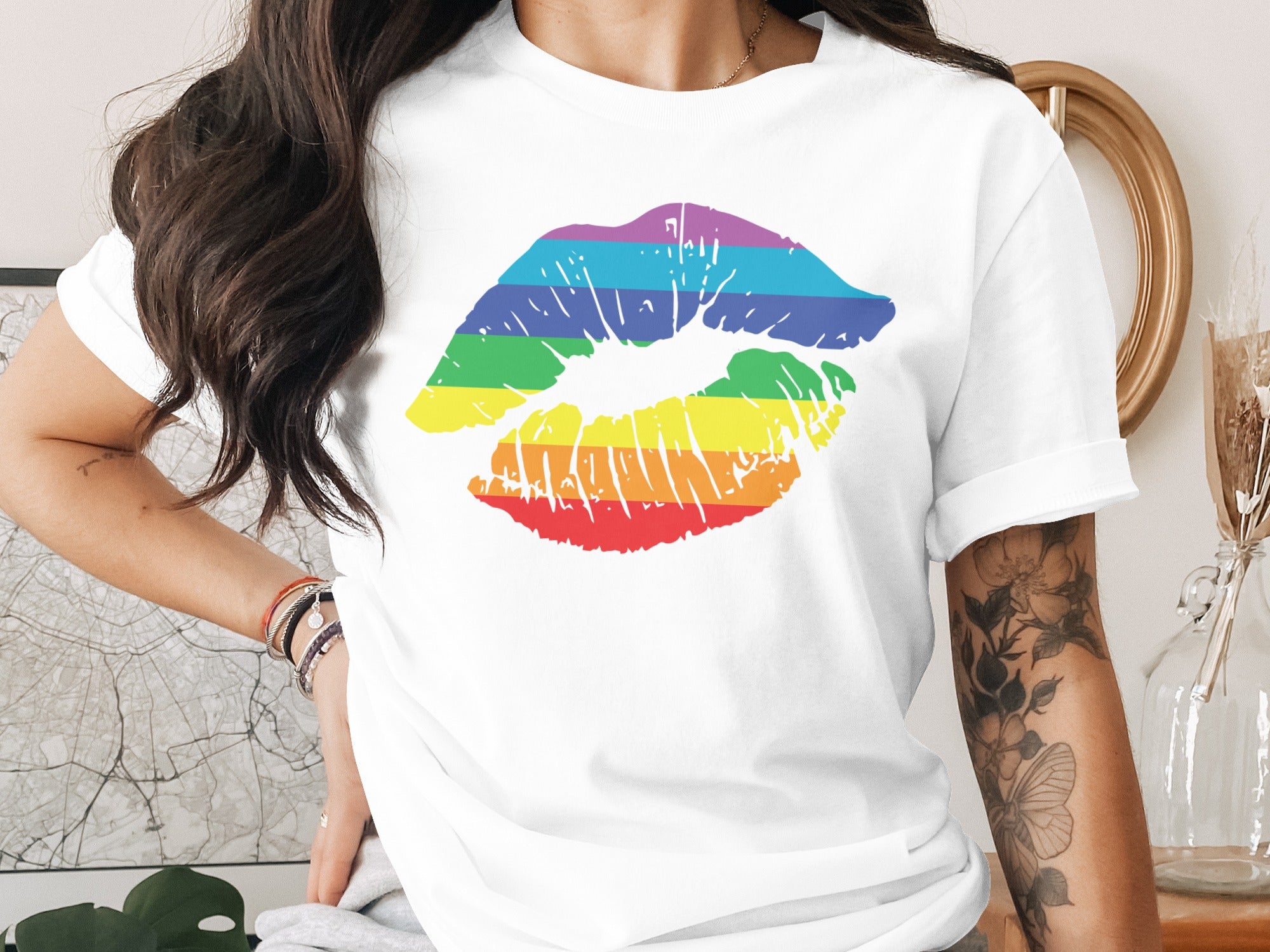 White t-shirt with a rainbow lipstick kiss print and floral arm tattoo.