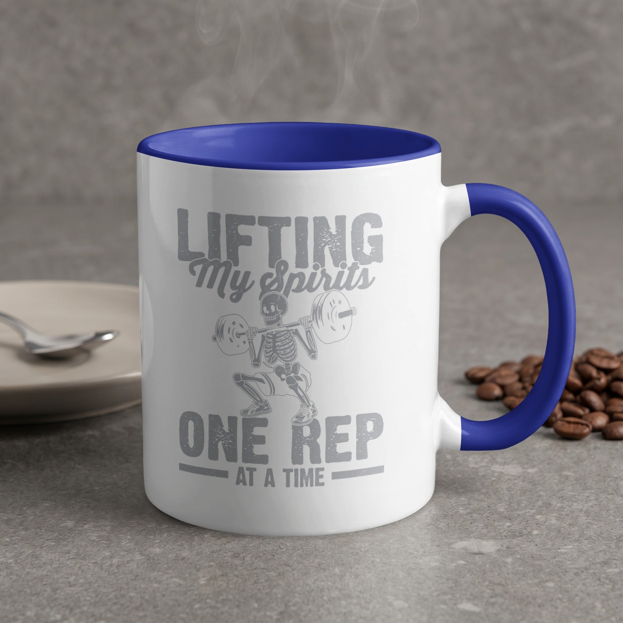 White mug with blue handle featuring skeleton lifting weights and text.