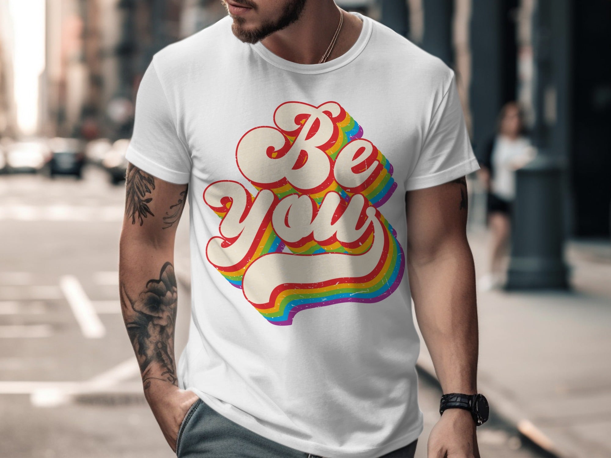 White t-shirt with "Be You" in retro rainbow lettering.