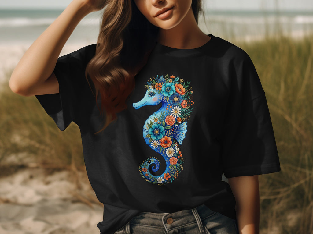 Black t-shirt with a blue seahorse design composed of colorful flowers and leaves.