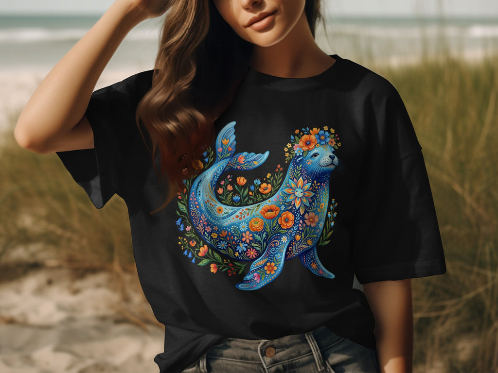 Black t-shirt featuring a blue seal adorned with colorful floral patterns.