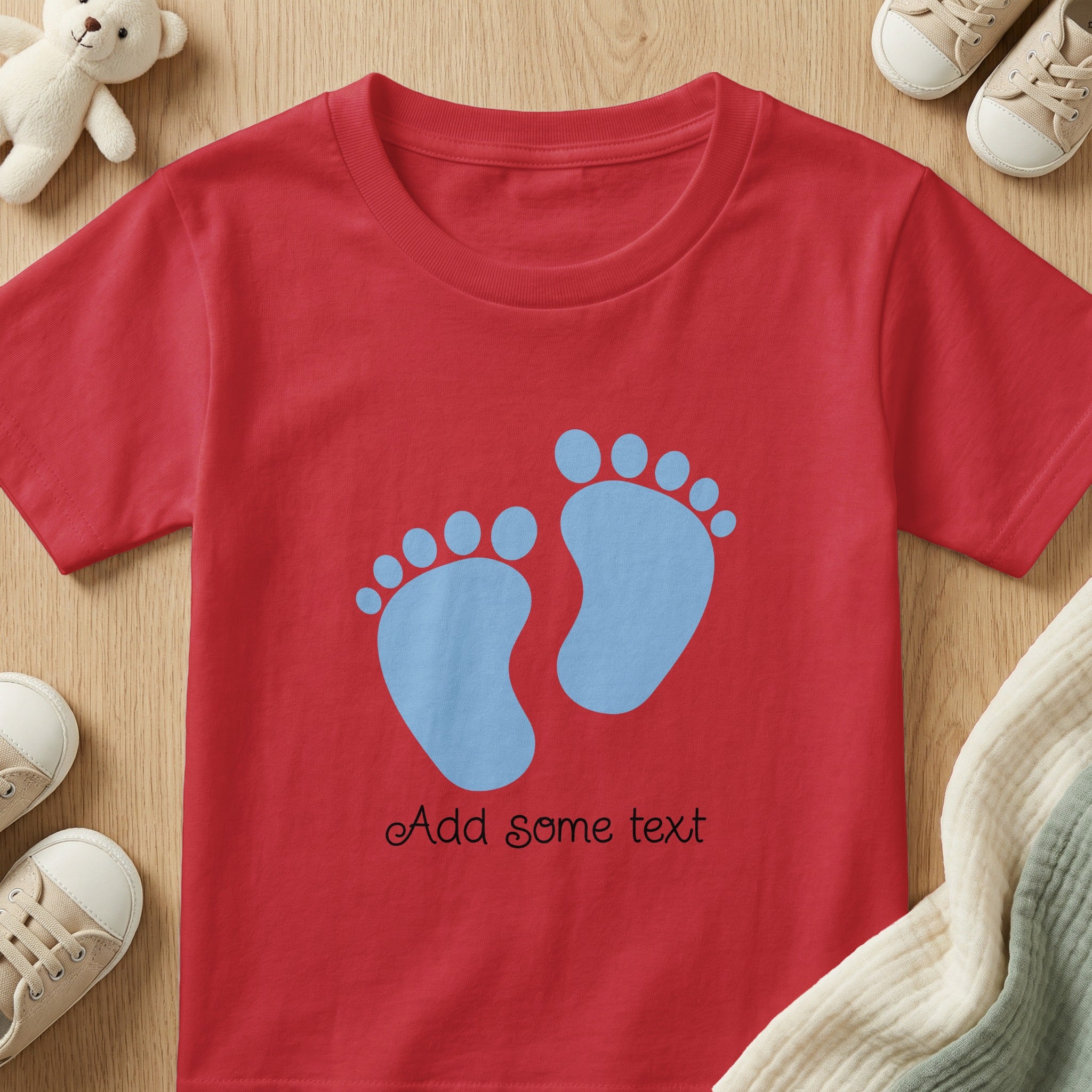 Red t-shirt with blue baby footprints and "Add some text" personalization.