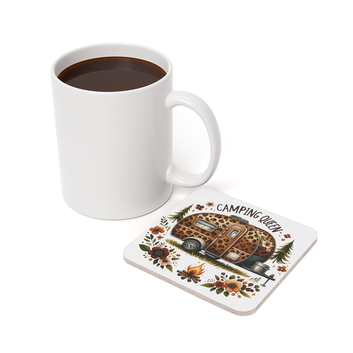 White mug next to a coaster with a leopard print camper, flowers, and "Camping Queen".