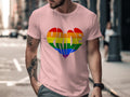 Pink t-shirt with rainbow pride heart graphic and wavy lettering.