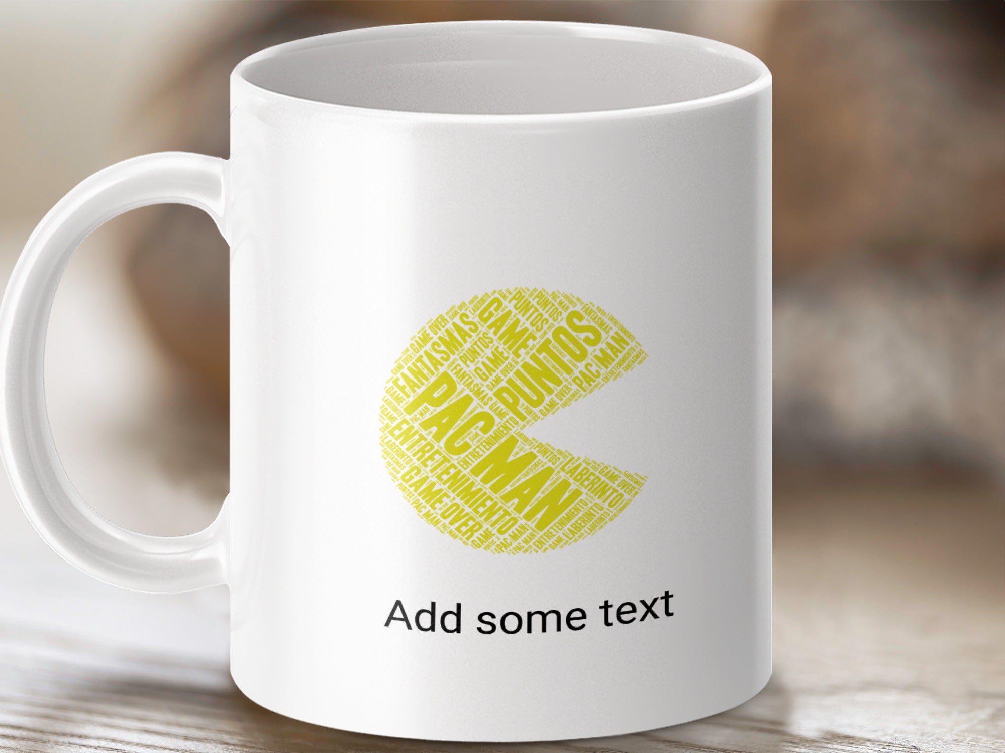 White mug with Pac-Man shape formed from game-related words and "Add some text."