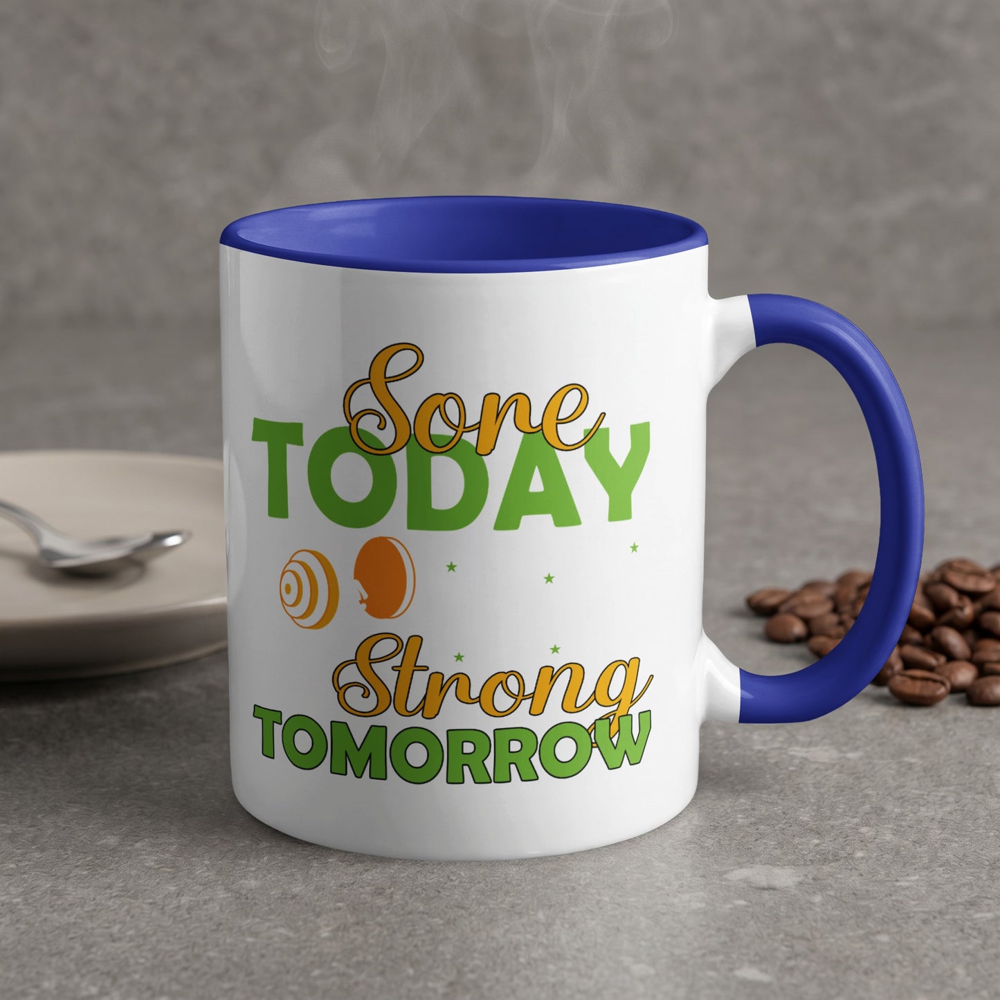 White mug with blue handle, "Done Today Strong Tomorrow" text, coffee beans.