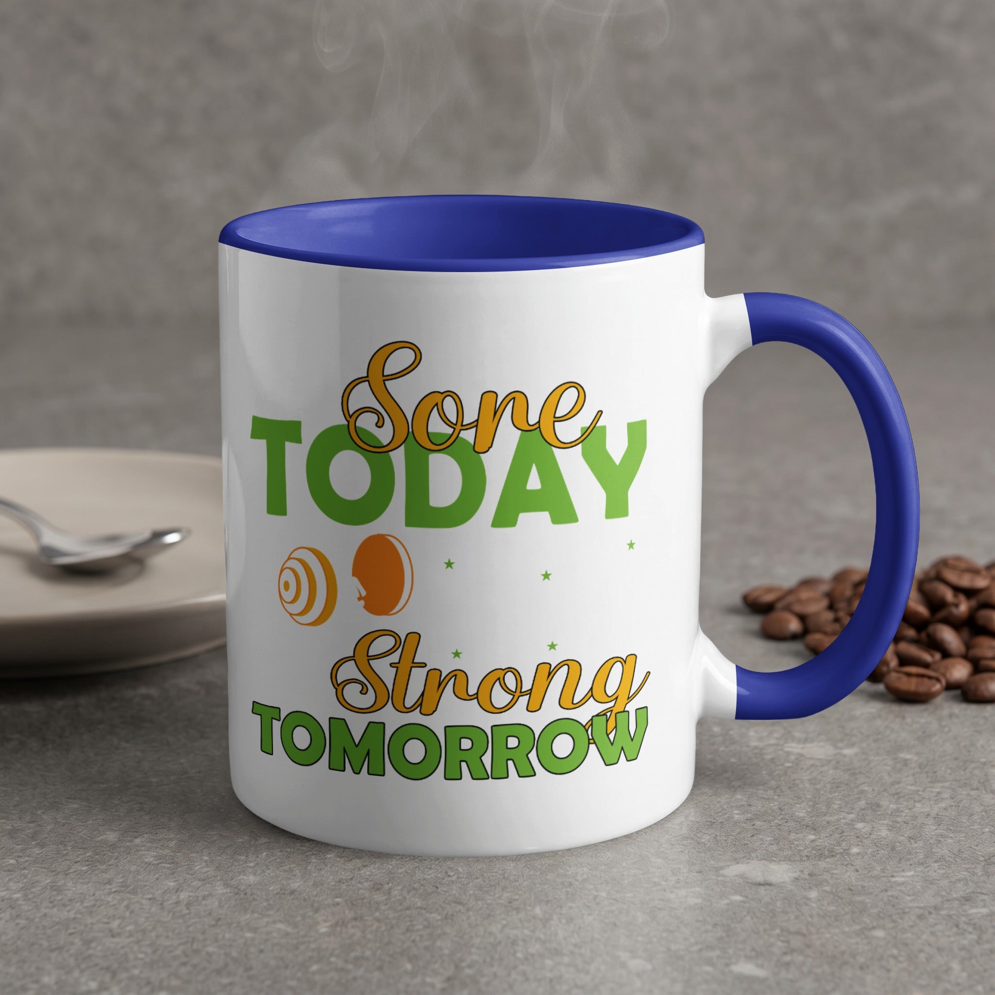 White mug with blue handle, "Done Today Strong Tomorrow" text, coffee beans.