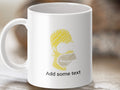 White mug with Homer Simpson's face made of "Homero" and "Padre" text.