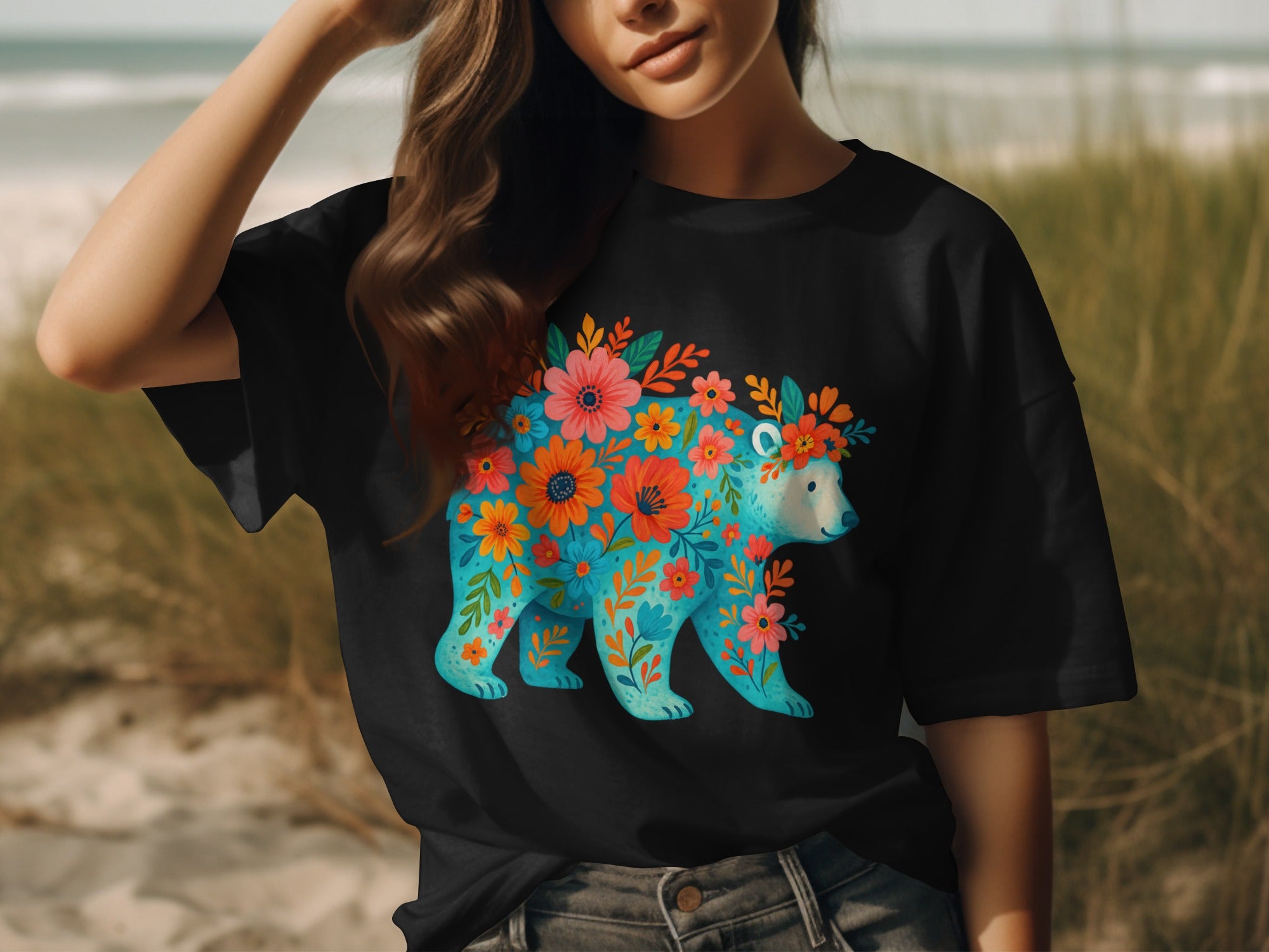 Black t-shirt with a turquoise bear illustration adorned with colorful flowers.