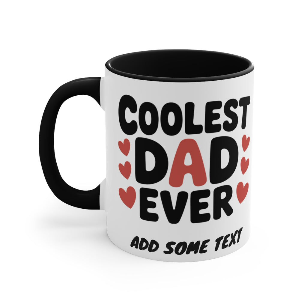 White mug with black rim and handle, "Coolest Dad Ever" text with red hearts.