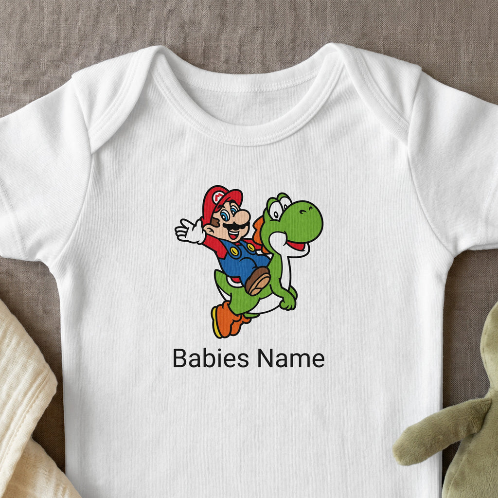 Mario riding Yoshi on a white baby onesie with text "Babies Name".