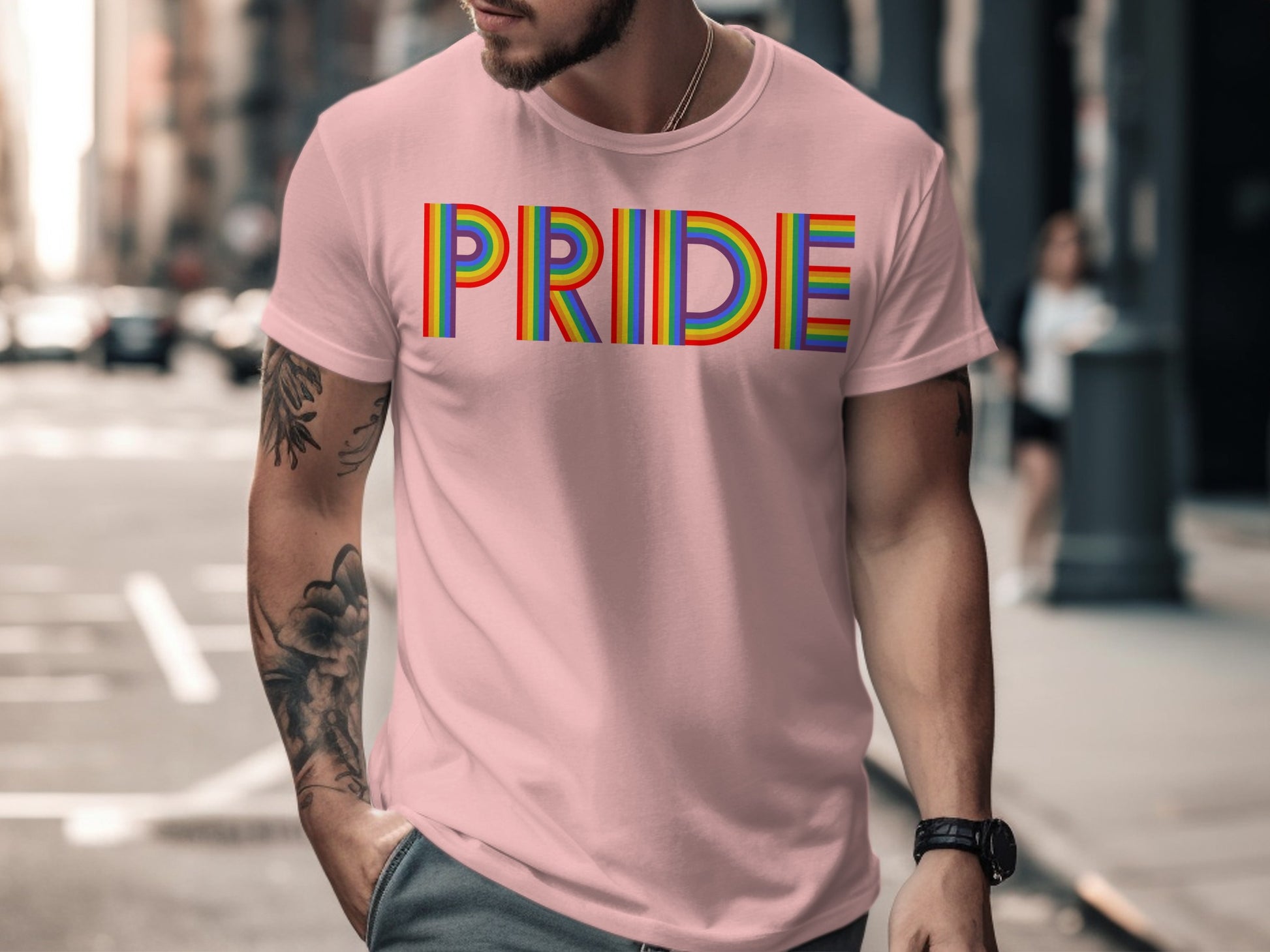 Pink t-shirt with rainbow "PRIDE" text and tattoos.
